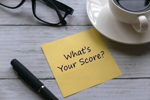 What's your score? written on a yellow paper next to a pen