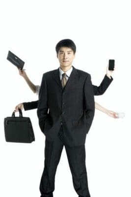 Busy businessman with four arms doing different tasks shows the disease busyness