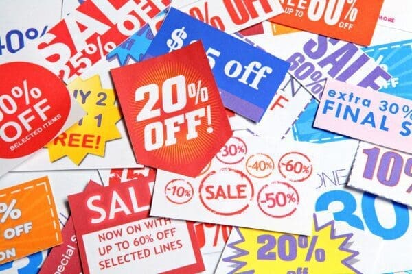 Colourful Discount coupons and Sale signs represent retailer marketing 