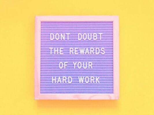 Don’t doubt the rewards of your hard work quote on felt board with yellow background