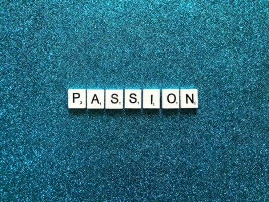 Passion spelled with word scramble cubes on a blue background