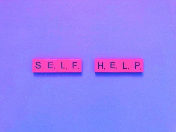 self-help spelled with pink tiles