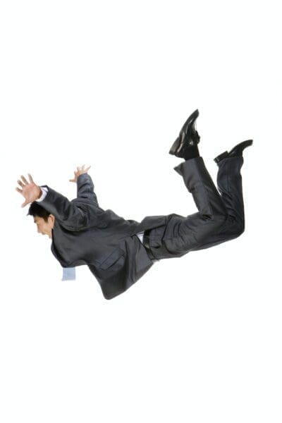 Young businessman falling with white background