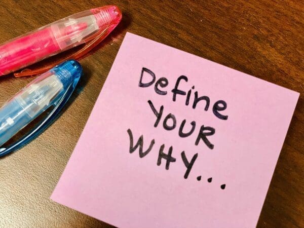 Define your why written on a pink post-it note