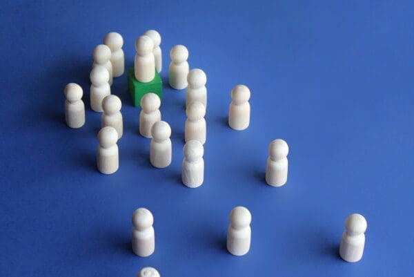 White leader figure on green stand for Leader, influencer, role model, followers concept