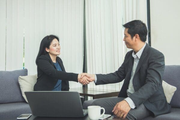 Businesswoman shaking hands with businessman after successful negotiation