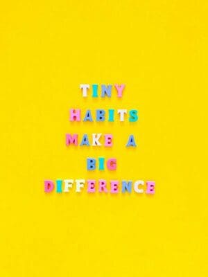 Tiny habits make a big difference written in colourful magnets on yellow background