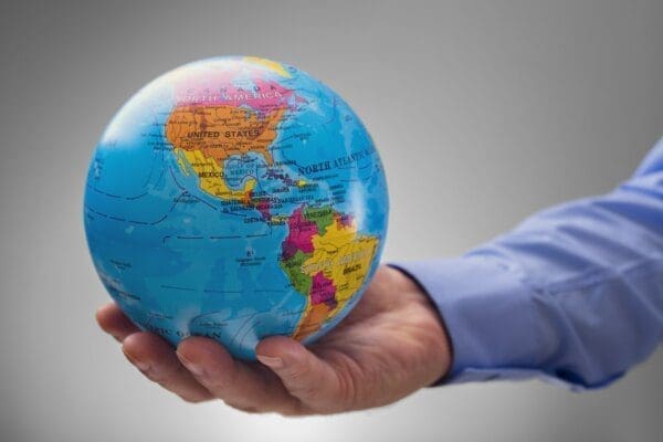 Businessman holding a small globe in his palm