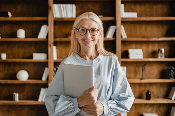 Businesswoman teacher boss holding a book in a library represents ENTP Personality Type for mbti articles