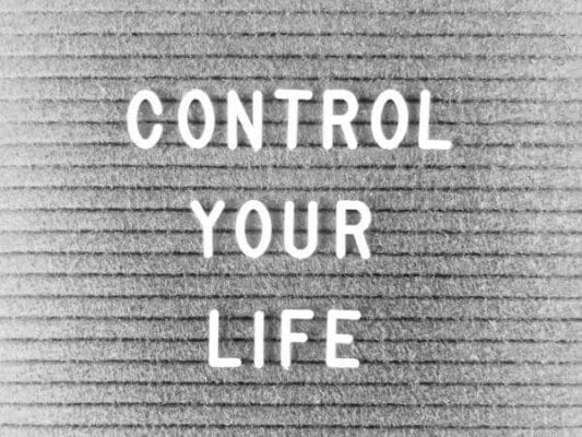 Control your life written on a grey felt board