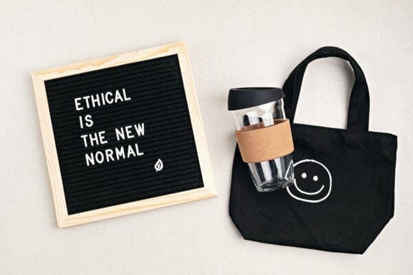 Ethical is the new normal on felt board with bag and cup next to it