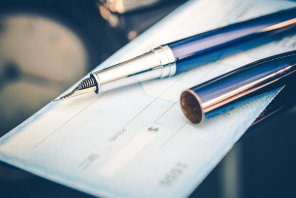 Close up of a cheque with a fountain pen