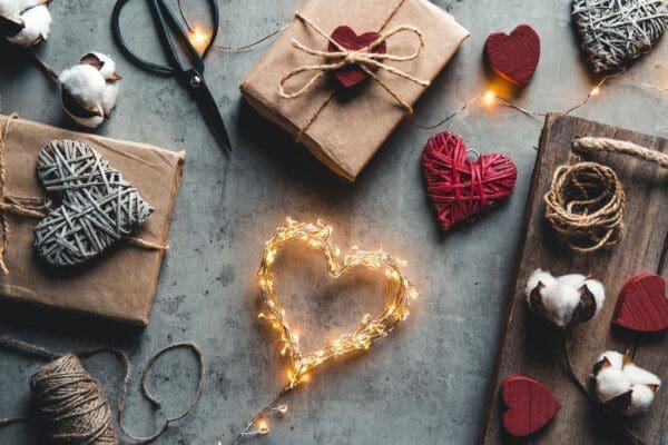 Wrapped gift with heart on surrounded by other heart