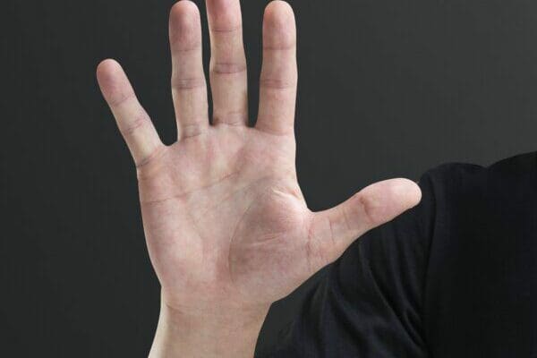Male hand palm showing five fingers gesture