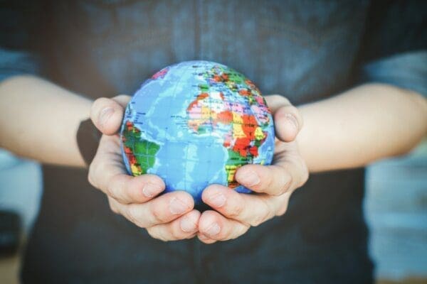 Close up of man's hands holding a small globe