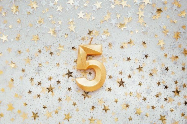 Number five 5 golden celebration birthday candle on Festive Background
