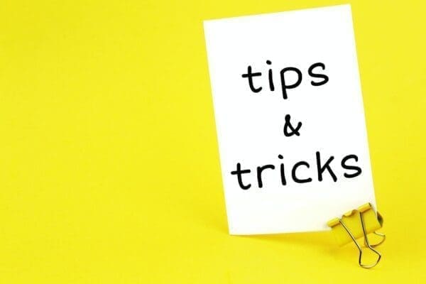 Tips & tricks on white sticker with paper clip on yellow background