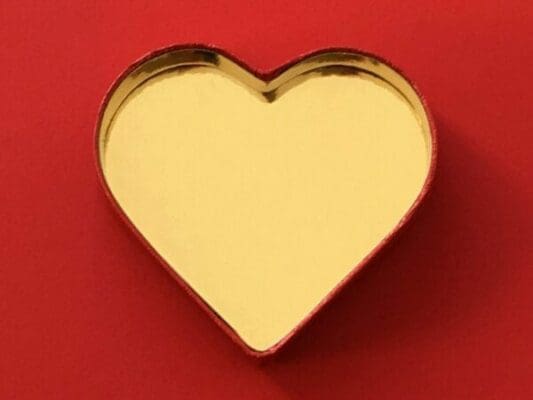 A gold heart on a red background