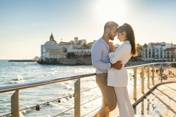 Romantic couple hugging on the promenade in bright daylight