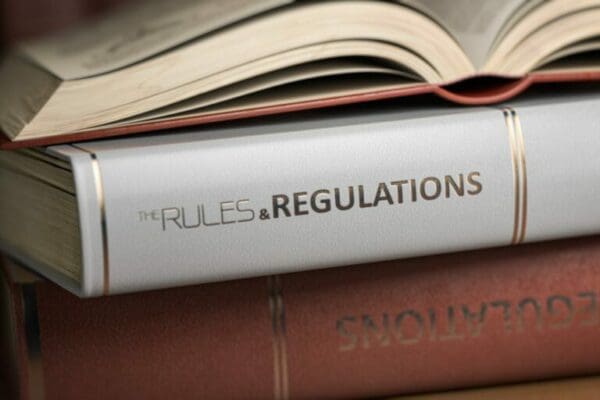 Close up of rules and regulations law book between two other books