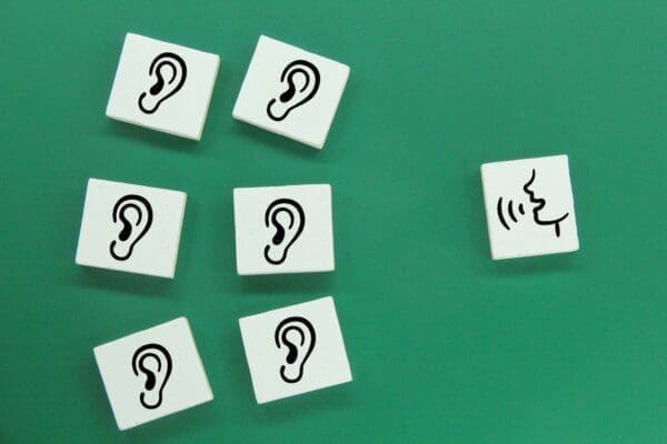 white square with talk and listen icons on green background