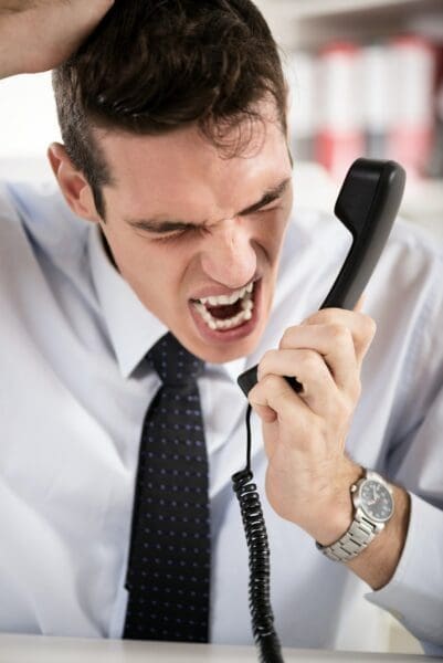 Close up of angry ISTP businessman shouting into the phone