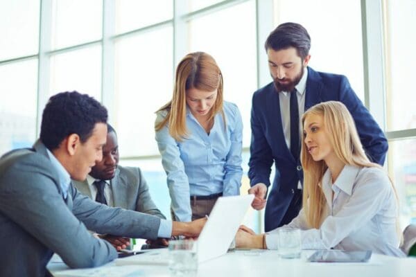 Group of business colleagues around a table communicating