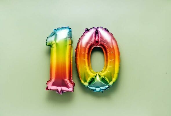 Colorful number 10 balloon on light green background