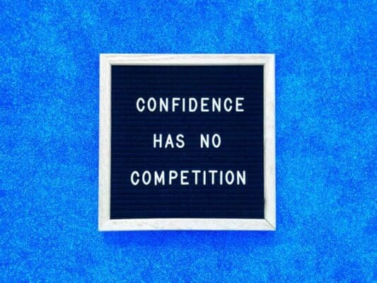 Confidence has no competition quote on felt board and blue background for persuasion technique