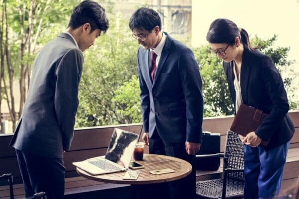 Japanese businesspeople greeting with bowing gesture to display respectful body language