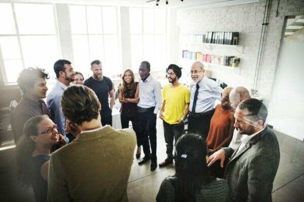 Group of work employees standing in a circle while using communication skills