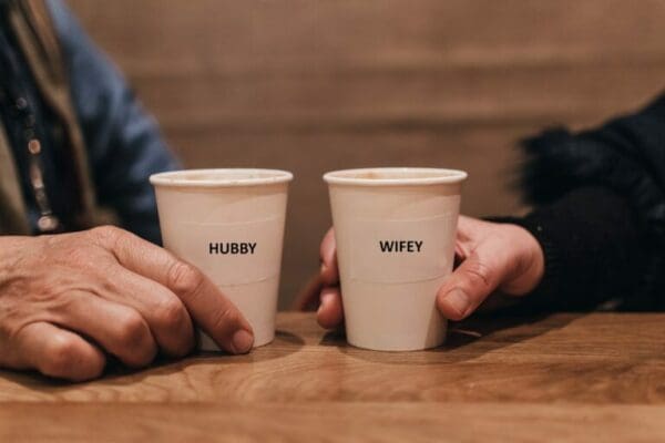 ESTJ Couple holding complementing coffee cups with hubby and wifey