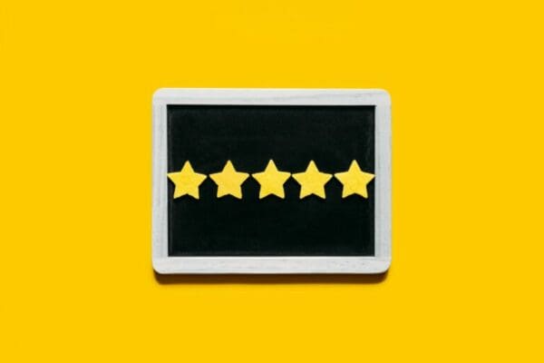 Five star rating on a black board with yellow background for excelling