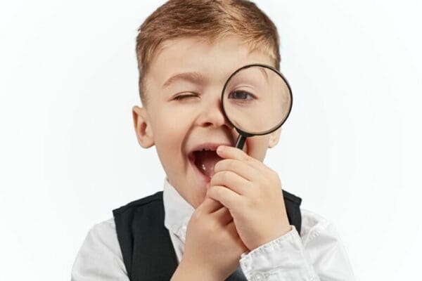 Baby boss manager using a magnifying glass to micromanage employees