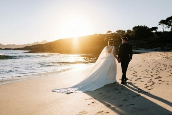 Just married ESTJ couple walking by the beach with sunset