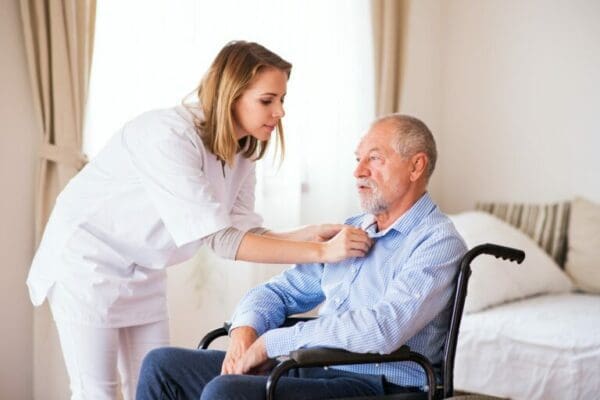 ESFJ nurse taking care of elderly man sitting in a wheelchair