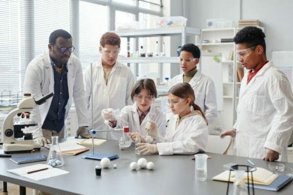 Students in white lab coats during a practical lesson in School Laboratory