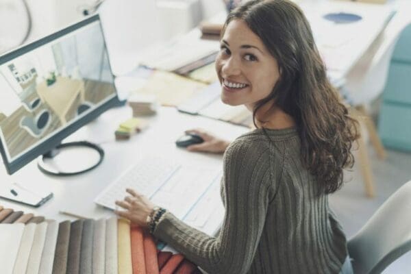 Smiling female coworker at desk shows positive body language