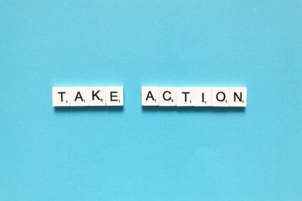 Take action spelt with white word scramble tiles on light blue background