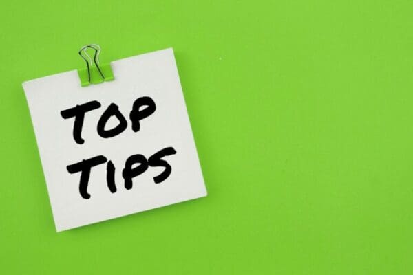 Top tips written on a white paper note against a green background