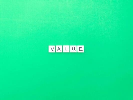Value spelt with white word scramble cubes on light green background