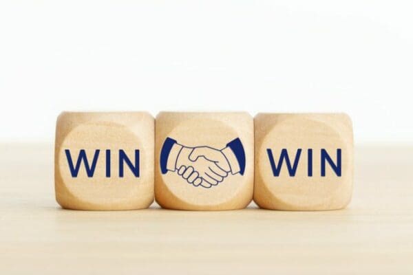 Win Win and a handshake drawing on wooden dice 