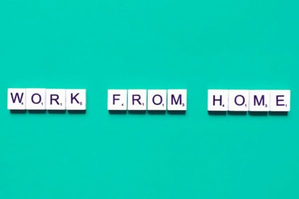 Work from home spelt with white tiles on light blue background