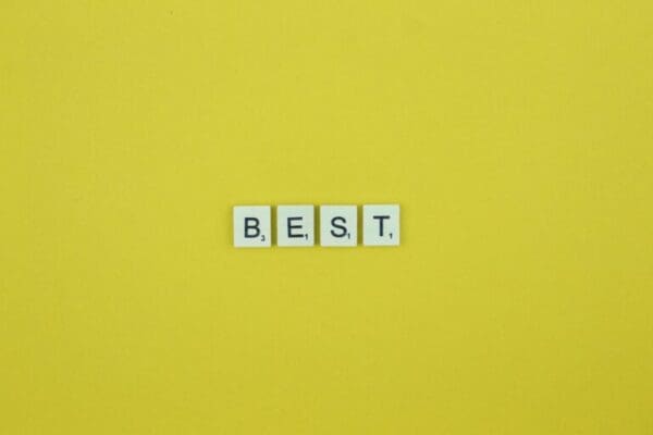 Best spelled with scrabble tiles on a yellow background