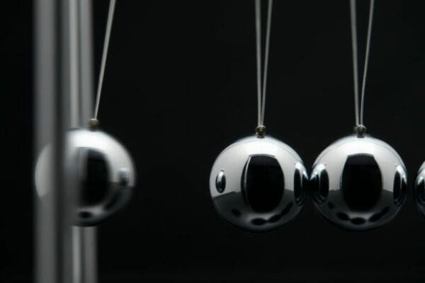 Closeup of swinging metal balls 