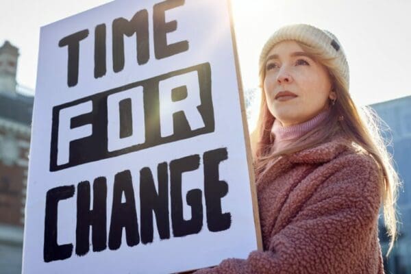 Female worker holding a time for change sign