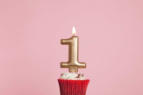 Gold number one birthday celebration candle on a cupcake