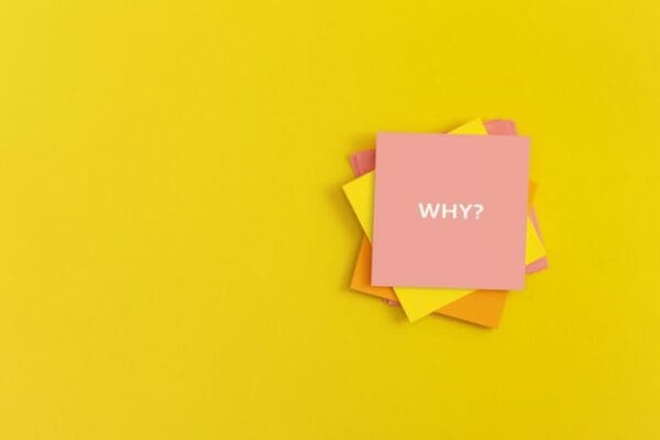 Sticky notes with the word WHY on yellow background