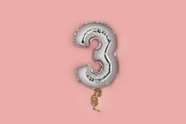 Silver Number 3 balloon on pink background