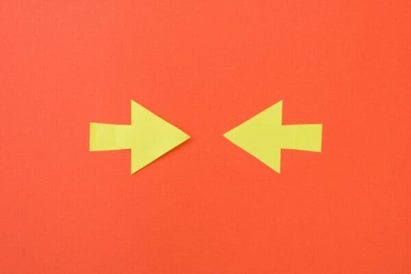 Two opposite yellow arrows pointing to the centeron orange background